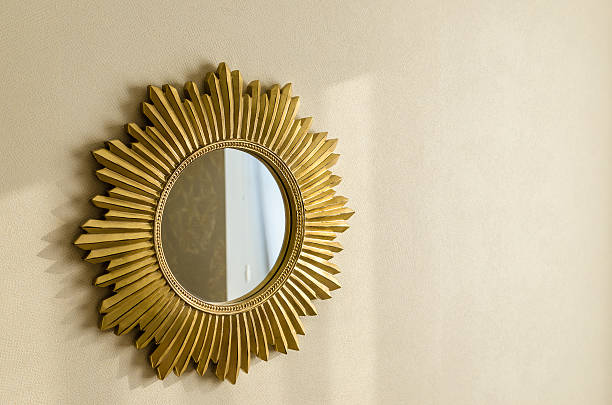 istock Golden modern mirror in shape of sun on the wall 627164284