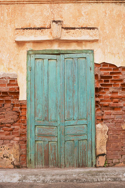 Old wall with framed green door stock photo