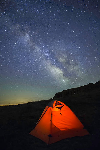 istock Orange tent under the milky way 627171392
