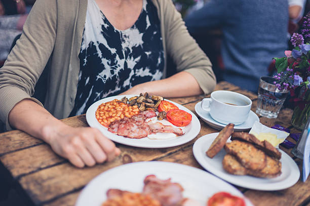 istock Young woman having an english breakfast 627176566