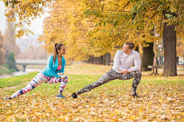 istock Beautiful young couple stretching together and preparing for run 627177514