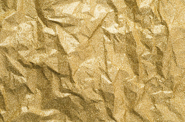 istock Gold wrinkled paper texture abstract background 627178198