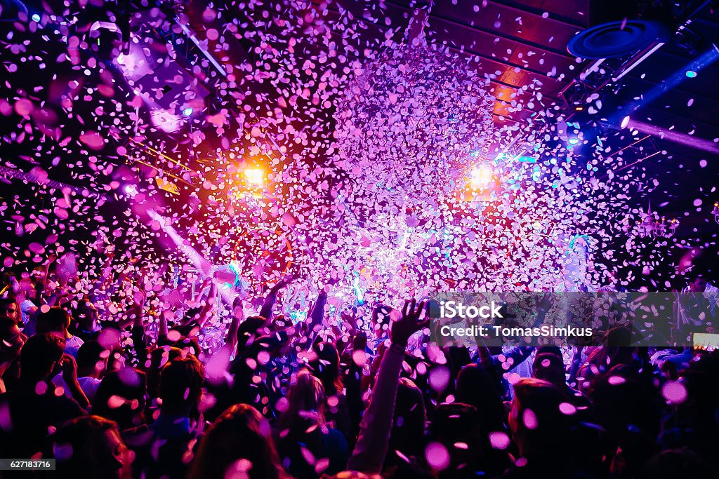 Concert Crowd Concert crowd - picture with a lof of people dancing i a concert, night club with raised their hands up! Amazing colours! Party - Social Event Stock Photo