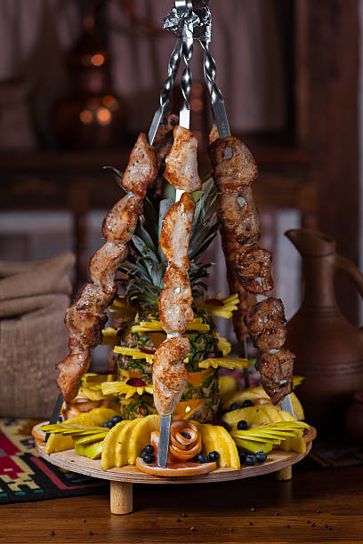 istock Grilled meat on skewer with fruits and pineapple on table 627183808