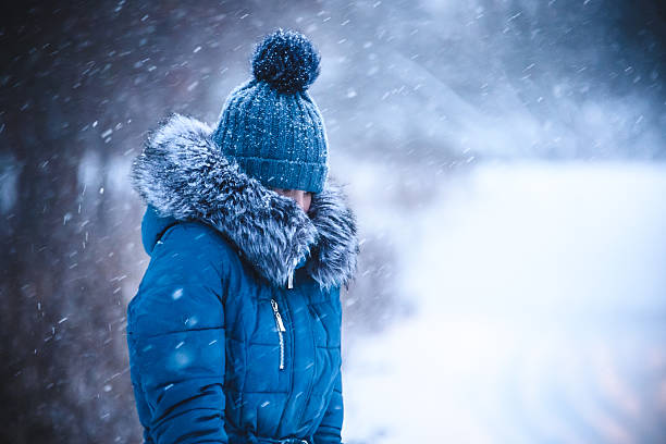 istock girl has muffled in a warm collar from a blizzard 627184942