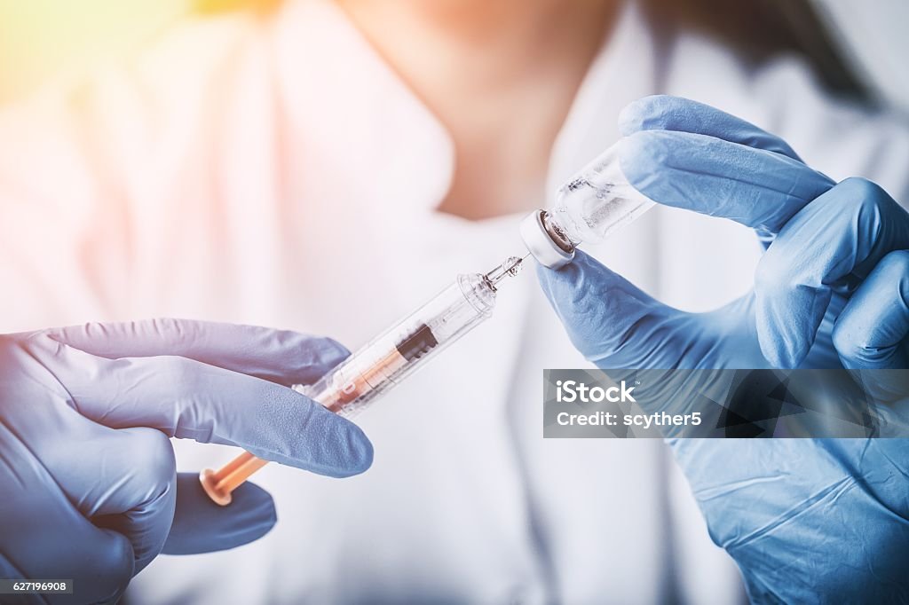 injecting injection vaccine vaccination medicine flu woman docto injecting injection vaccine vaccination medicine flu man doctor insulin health drug influenza concept - stock image Vaccination Stock Photo