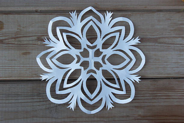 istock paper snowflake on the wooden table 627197094