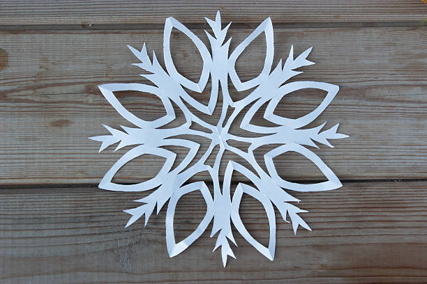 istock paper snowflake on the wooden table 627197164