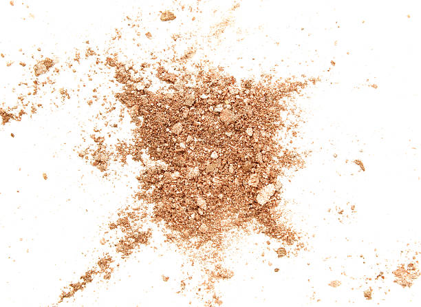 istock Crushed golden eye shadow isolated on white background 627198858