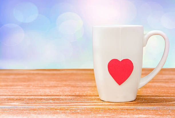 istock Mug with a heart on a wooden table. 627199908