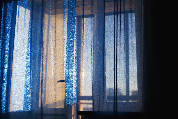 istock blue curtain, sunrise in window, balcony door 627200072