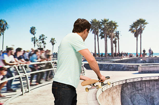 istock Man holding skateboard at venice beach 627201972