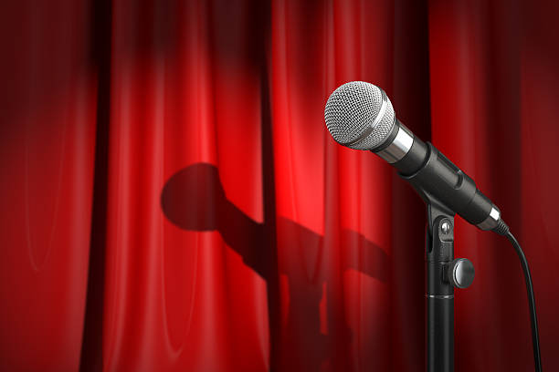 istock Microphone on stage with red curtain. Music or performance  conc 627201978