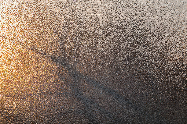 istock Water drops on a window glass with trees silhouette. 627202184