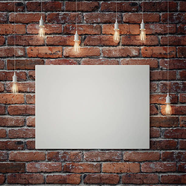 White poster with light bulbs on red brick wall
