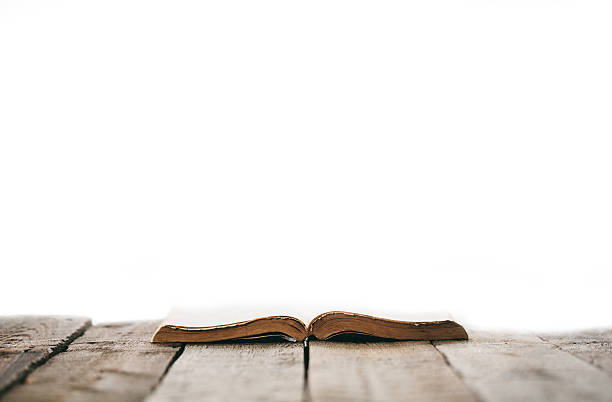 istock Old bible on a wooden table 627203408