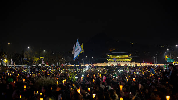 Demonstrators Seoul, South Korea - November 12, 2016: Hundreds of thousands of people gathered at a rally to demand the ouster of President Park Geun-hye. korean protest stock pictures, royalty-free photos & images