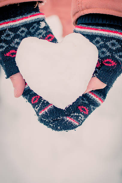 istock Girl with snow heart 627210038