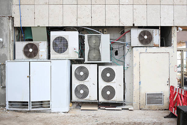 istock Air conditioner compressors on the street 627210398