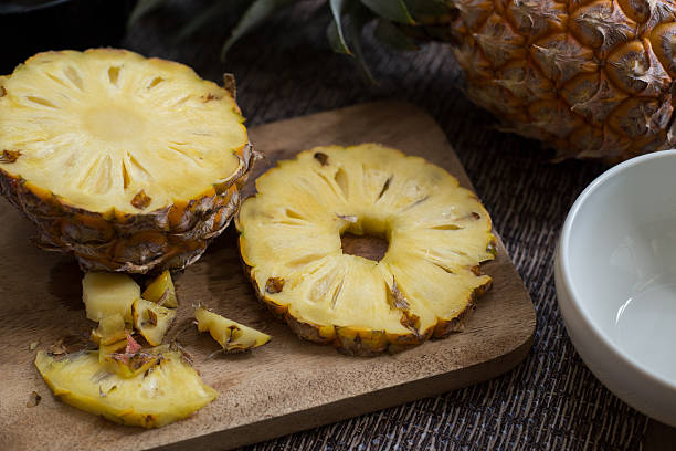 istock pineapple ftuit and slices on the table. 627216076