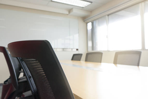 istock wooden table in meeting room white board sunlight from window 627216346