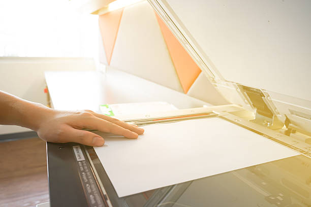 man copying paper from photocopier sunlight from window - print computer printer printout push button imagens e fotografias de stock