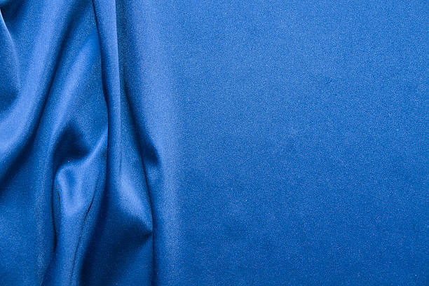 Blue silk background. Abstract wavy texture stock photo