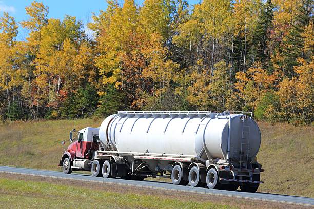 istock Semi tanker on an interstate highway, trees in background. 627226376
