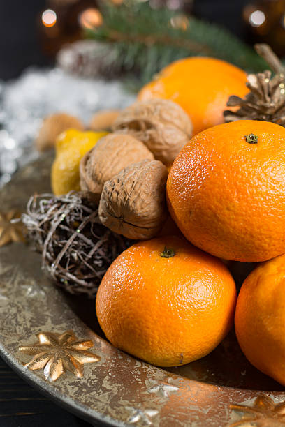 istock Winter cristmas fruits and nuts on silver plate 627226724