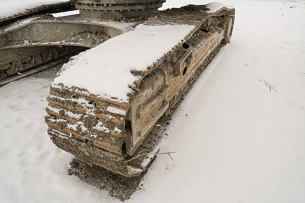 Closeup of a caterpillar wheel under snow in winter