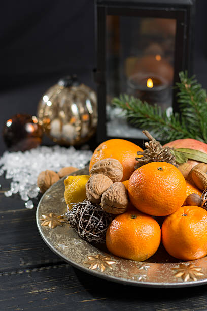 istock Winter christmas fruits and nuts on silver plate 627227258