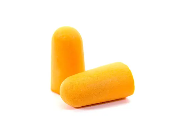Photo of Foam ear plugs isolated on white background.Orange ear plugs isolated