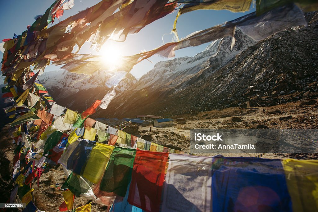 Tibetan Flags on Annapurna Base Camp in Nepal Tibetan Flags on Annapurna Base Camp in Nepal, Himalaya. Sunrise above Machapuchare mountain Activity Stock Photo