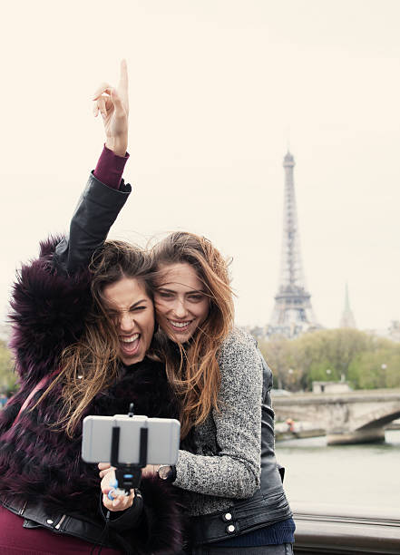 istock Women making selfie with monopod in front of Eiffel tower 627227988