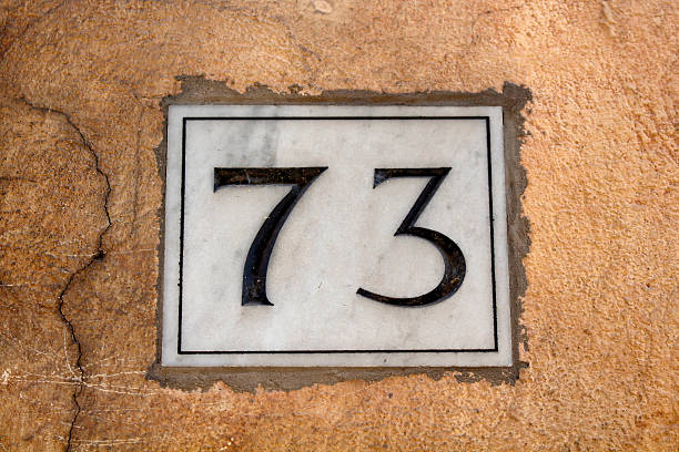 istock View of a building number (73) in Rome. 627228482