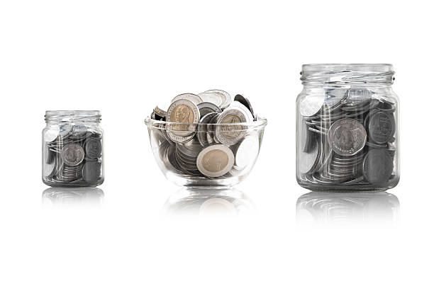 istock coins in a glass jar against 627229346