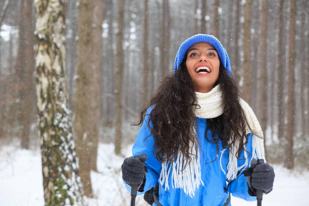 istock Young woman hiking in the snow forest 627229502