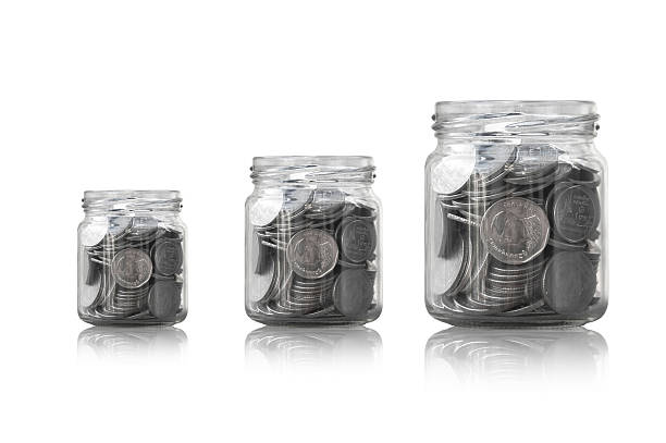 istock coins in a glass jar against 627229526