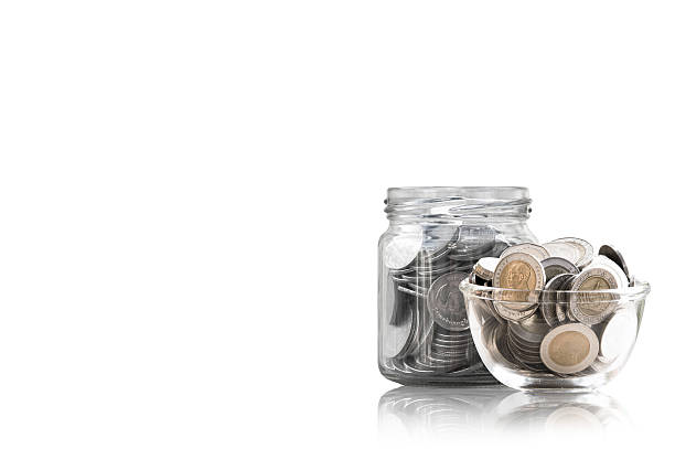 istock coins in a glass jar against 627229854