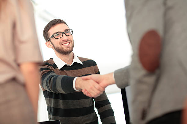 istock Manager greeting new employee and smiling in office 627231056