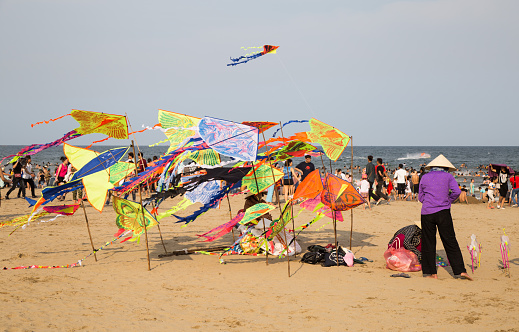 Thanh Hoa, Vietnam - April 30, 2016: Vietnamese vendor selling made in China toys and kite on the beach of Tinh Gia district.
