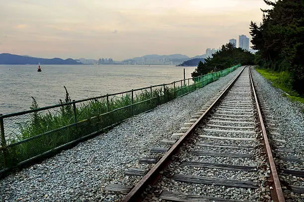 Horizon of the Rail way beside the sea at sunset