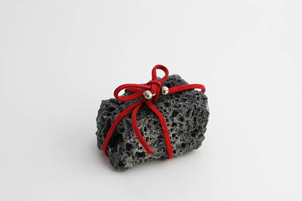 Christmas coal Christmas coal with red ribbon, sweet gift for naughty boys bumpy stock pictures, royalty-free photos & images