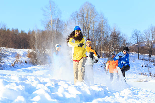 istock Group of friends running and having fun in snow 627249328