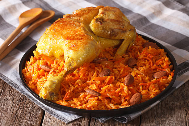 istock Arabic food: kabsa with chicken and almonds close-up 627249368