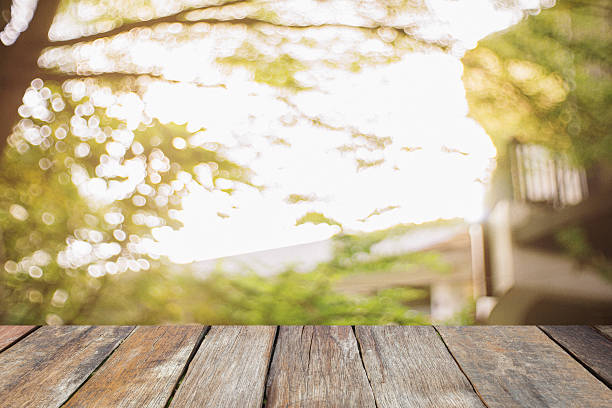 istock Wood table top on blurred Image of color from nature 627249732