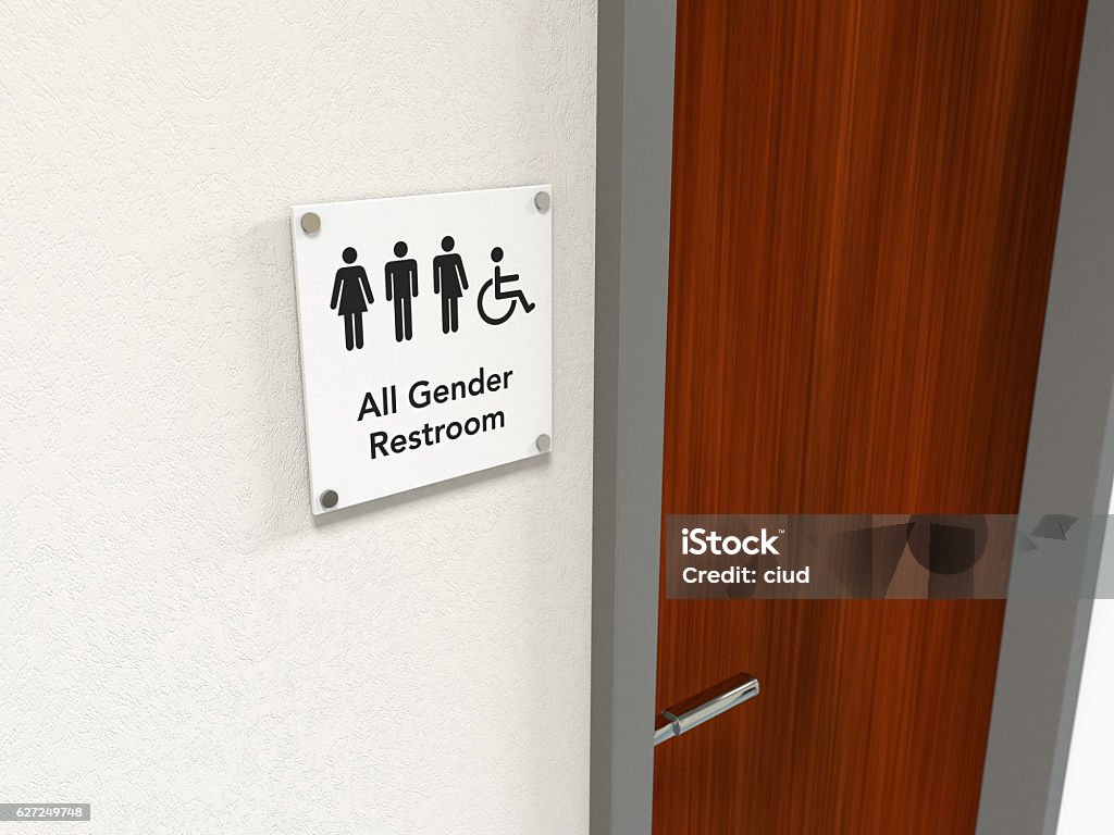 All Gender Restroom Signage An all gender rest room sign next to a wooden bathroom door; black icons on white background Door Stock Photo