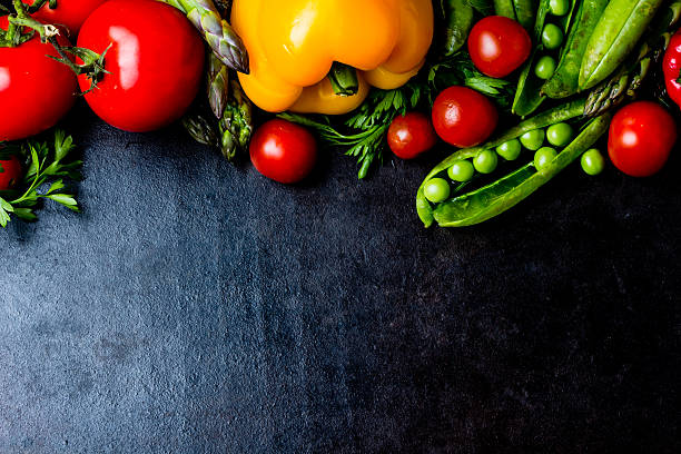 istock Food background. Fresh vegetables on black. Top view 627250366