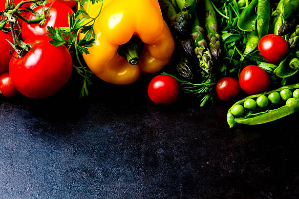 istock Food background. Fresh vegetables on black. Top view 627250490