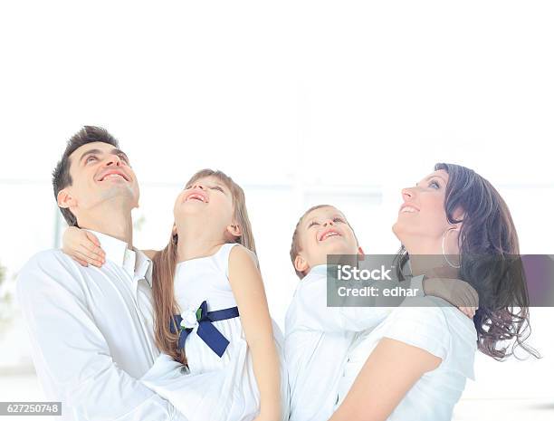 Harmonious Family Laying Down And Looking Up Stock Photo - Download Image Now - Adult, Boys, Cheerful